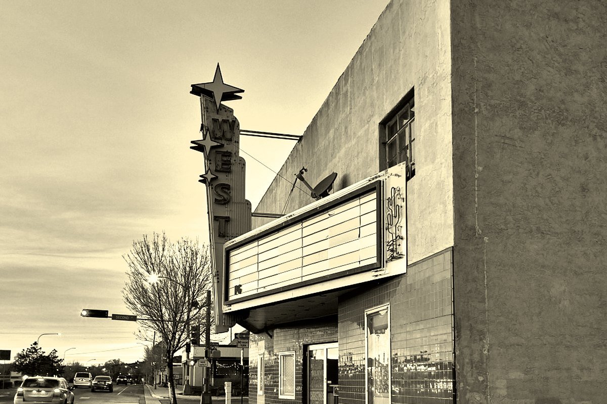 The West Theatre marquee and star sign at dusk on the main street of Grants, New Mexico